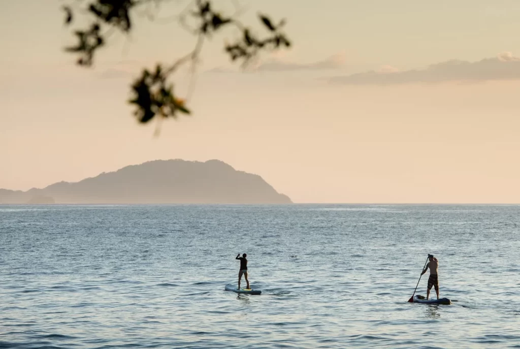 Family on a paddle board exploring a calm bay